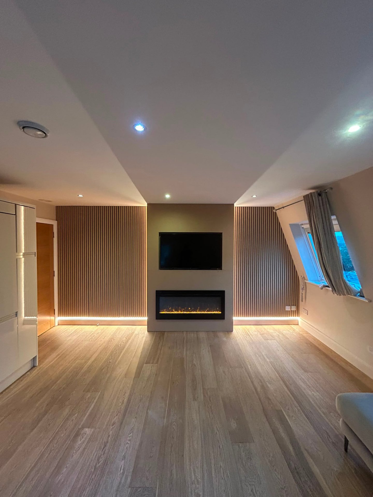 Completed media wall with slatted panelling and inset fire at Cuffley